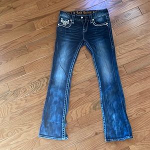 Rock Revival Mid-rise boot cut, size 26, regular length dark denim jean.